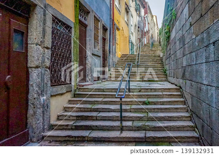 The stone steps and alleys of Porto's old town: narrow, sloping streets and historic streetscapes. The stone steps and alleys of Porto's old town: narrow, sloping streets and historic streetscapes. 139132931