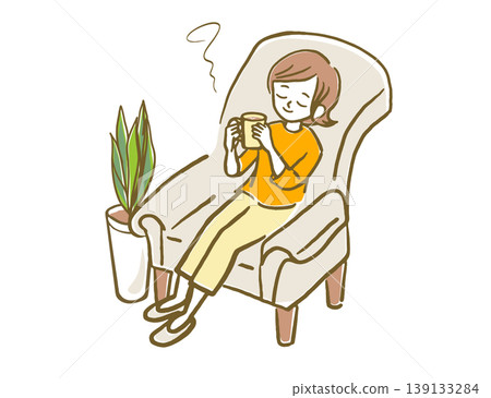 A woman relaxing on a sofa with a mug in her hand. A woman relaxing on a sofa with a mug in her hand. 139133284