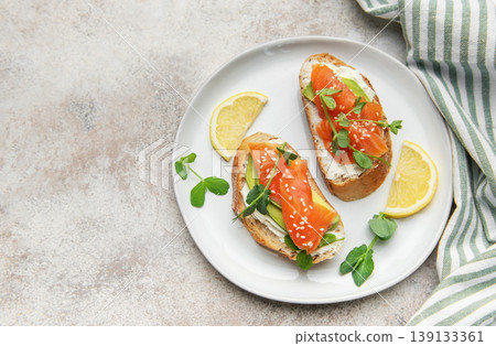 Salmon avocado toasts with cream cheese and microgreens Salmon avocado toasts with cream cheese and microgreens 139133361
