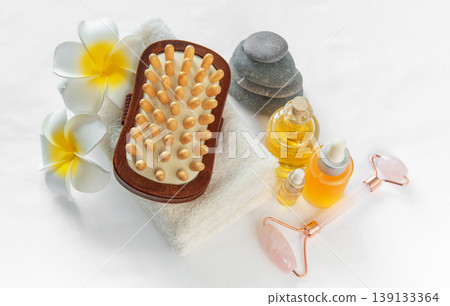 Spa wellness treatment with massage oil and stones 139133364