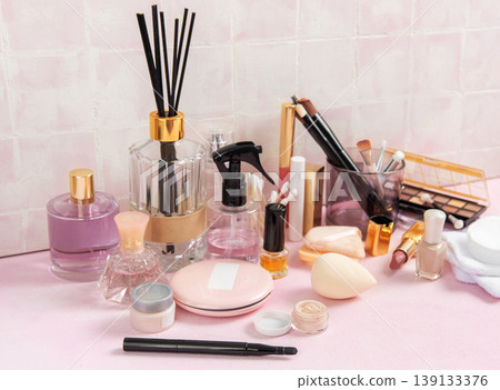 Cosmetic products and personal care accessories on pink surface 139133376