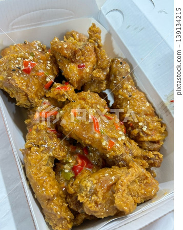 Crispy fried chicken with golden, crunchy skin and juicy, tender meat. A delicious and savory dish, perfect for any meal, served with dipping sauces or side dishes for extra flavor! 139134215