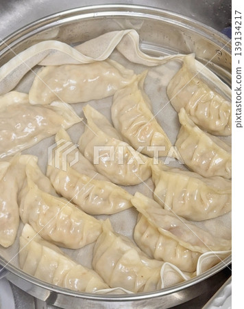 Korean dumplings filled with a mix of savory ingredients like ground meat, tofu, and vegetables. Mandu can be steamed, boiled, or pan-fried, making it a versatile and delicious snack or meal. Korean dumplings filled with a mix of savory ingredients like ground meat, tofu, and vegetables. Mandu can be steamed, boiled, or pan-fried, making it a versatile and delicious snack or meal. 139134217