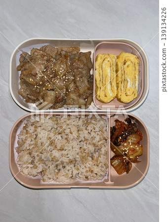 Bento or dosirak box filled with rice, assorted side dishes, vegetables, and protein like meat or fish, all neatly arranged to create a balanced, colorful, and visually appealing meal Bento or dosirak box filled with rice, assorted side dishes, vegetables, and protein like meat or fish, all neatly arranged to create a balanced, colorful, and visually appealing meal 139134226