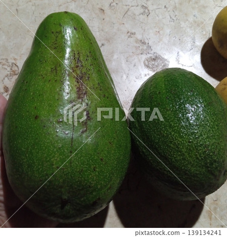 Fresh whole avocado with smooth, dark green skin and rich, creamy texture. Perfect for healthy eating, salads, smoothies, and guacamole. Nutritious, delicious, and full of flavor! Fresh whole avocado with smooth, dark green skin and rich, creamy texture. Perfect for healthy eating, salads, smoothies, and guacamole. Nutritious, delicious, and full of flavor! 139134241