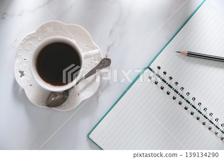 top table view of coffee, notebook, and pencil, a creative breakfast journaling idea. top table view of coffee, notebook, and pencil, a creative breakfast journaling idea. 139134290