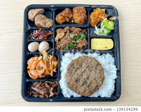 Bento or dosirak box filled with rice, assorted side dishes, vegetables, and protein like meat or fish, all neatly arranged to create a balanced, colorful, and visually appealing meal Bento or dosirak box filled with rice, assorted side dishes, vegetables, and protein like meat or fish, all neatly arranged to create a balanced, colorful, and visually appealing meal 139134299
