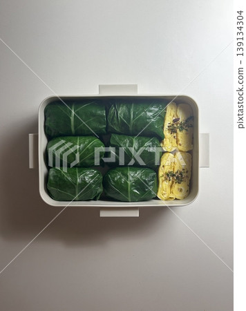 Bento or dosirak box filled with rice, assorted side dishes, vegetables, and protein like meat or fish, all neatly arranged to create a balanced, colorful, and visually appealing meal Bento or dosirak box filled with rice, assorted side dishes, vegetables, and protein like meat or fish, all neatly arranged to create a balanced, colorful, and visually appealing meal 139134304