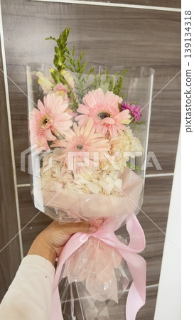 Bouquet of fresh flowers with vibrant colorful petals and lush green leaves, carefully arranged to highlight natural beauty, soft textures, and harmonious elegance in close-up detail Bouquet of fresh flowers with vibrant colorful petals and lush green leaves, carefully arranged to highlight natural beauty, soft textures, and harmonious elegance in close-up detail 139134318