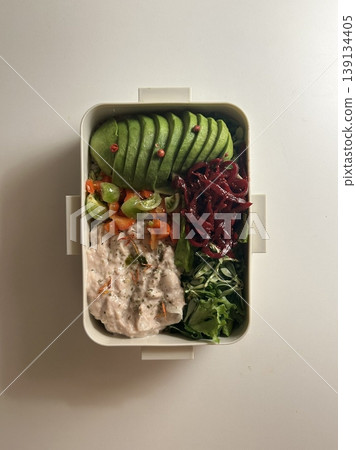 Bento or dosirak box filled with rice, assorted side dishes, vegetables, and protein like meat or fish, all neatly arranged to create a balanced, colorful, and visually appealing meal Bento or dosirak box filled with rice, assorted side dishes, vegetables, and protein like meat or fish, all neatly arranged to create a balanced, colorful, and visually appealing meal 139134405