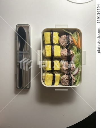 Bento or dosirak box filled with rice, assorted side dishes, vegetables, and protein like meat or fish, all neatly arranged to create a balanced, colorful, and visually appealing meal Bento or dosirak box filled with rice, assorted side dishes, vegetables, and protein like meat or fish, all neatly arranged to create a balanced, colorful, and visually appealing meal 139134594