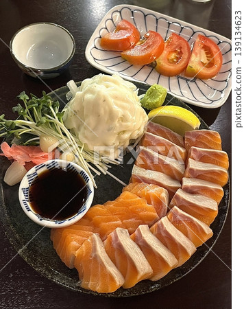 Fresh and delicate sashimi slices, beautifully presented with vibrant colors and perfect cuts. This traditional Japanese delicacy highlights the pure flavors of premium seafood. Fresh and delicate sashimi slices, beautifully presented with vibrant colors and perfect cuts. This traditional Japanese delicacy highlights the pure flavors of premium seafood. 139134623