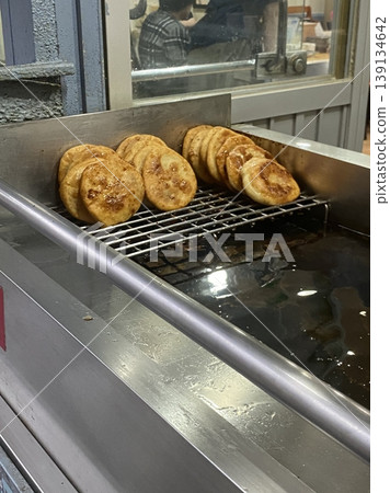 Golden, crispy Hotteok, a popular Korean street snack filled with gooey, sweet syrup, brown sugar, and nuts. Perfectly warm and satisfying with each chewy bite. Golden, crispy Hotteok, a popular Korean street snack filled with gooey, sweet syrup, brown sugar, and nuts. Perfectly warm and satisfying with each chewy bite. 139134642