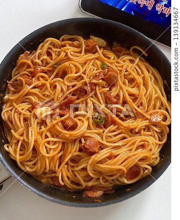 Classic spaghetti coated in rich tomato sauce, offering a simple yet delicious combination of tangy, savory flavors perfect for a comforting meal. 139134667
