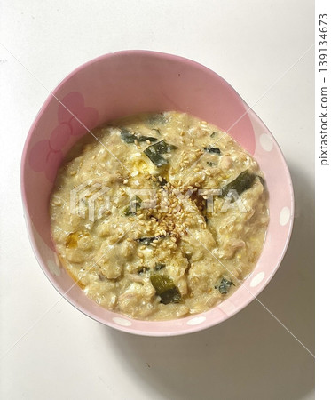 Warm and comforting juk (Korean rice porridge) with a smooth, velvety texture, offering a perfect blend of gentle flavor and nourishing simplicity in every soothing, satisfying spoonful. 139134673