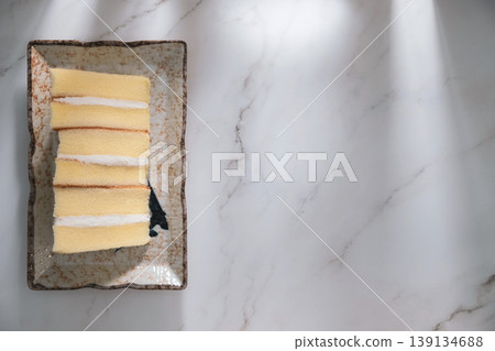 Sponge cake on marble background with copy space for text. Sponge cake on marble background with copy space for text. 139134688