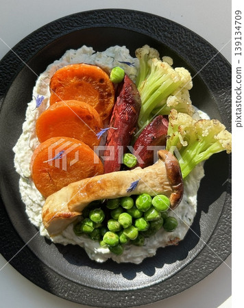 A delightful brunch spread featuring a mix of savory and sweet dishes, including fresh pastries, eggs, seasonal fruits, and a hot beverage. A perfect mid-morning indulgence. 139134709