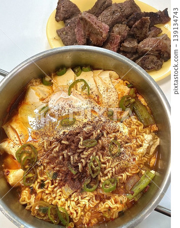 Spicy Shin ramyeon with bold, flavorful broth, served alongside fresh kimbap and tangy kimchi. A perfect trio of comforting, savory, and spicy Korean favorites in every bite. Spicy Shin ramyeon with bold, flavorful broth, served alongside fresh kimbap and tangy kimchi. A perfect trio of comforting, savory, and spicy Korean favorites in every bite. 139134743