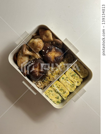 Bento or dosirak box filled with rice, assorted side dishes, vegetables, and protein like meat or fish, all neatly arranged to create a balanced, colorful, and visually appealing meal 139134813