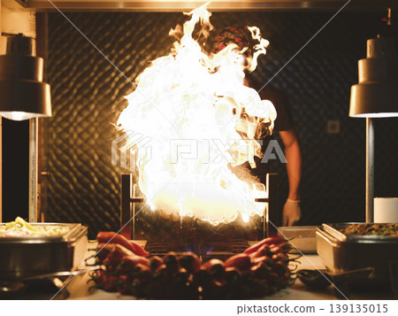 a chef cooking at a hotel buffet a chef cooking at a hotel buffet 139135015