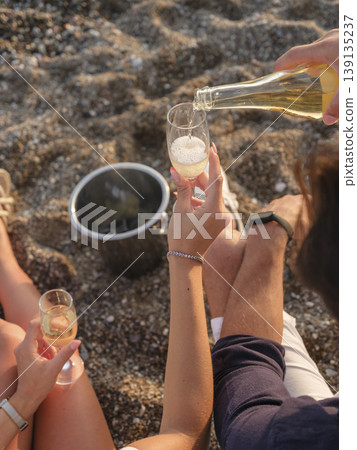 couple celebrating on the beach couple celebrating on the beach 139135237