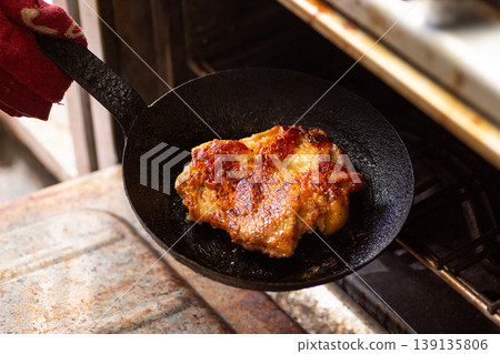 Bake chicken steak in the kitchen oven. Bake chicken steak in the kitchen oven. 139135806