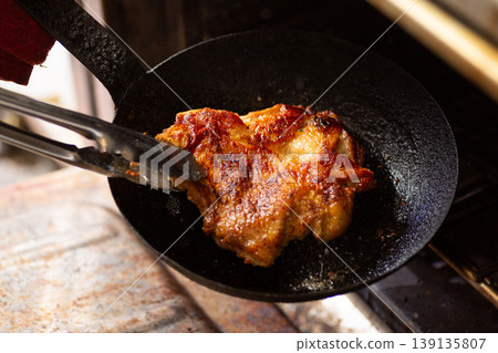 Bake chicken steak in the kitchen oven. Bake chicken steak in the kitchen oven. 139135807