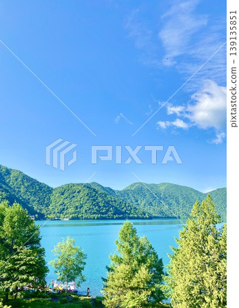 Lake Chuzenji in early summer, enveloped in fresh greenery. 139135851