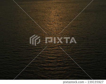 sunset reflecting on sea waves 139135927