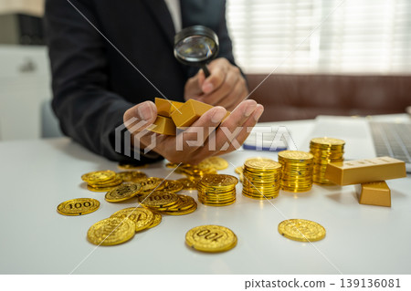 Businessman calculating rising costs with gold coins, inflation and financial growth concept. 139136081