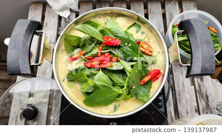 Homemade Thai Green Curry with Fresh Basil and Red Chilies in a Pot 139137987