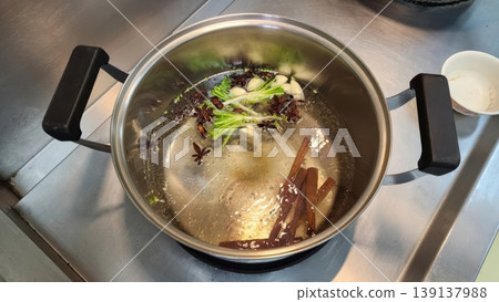 Preparing Aromatic Asian Broth with Star Anise Cinnamon and Scallions 139137988