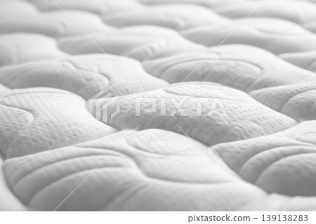 Mattress pattern. Close-up of a white mattress topper, featuring a textured, wavy surface with small perforations. Grounding Bed. Soft wave quilted ornament of bedding. Comfortable sleep and dreams 139138283