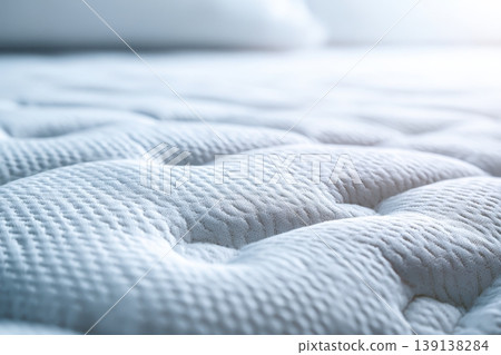 Mattress pattern. Close-up of a white mattress topper, featuring a textured, wavy surface with small perforations. Grounding Bed. Soft wave quilted ornament of bedding. Comfortable sleep and dreams 139138284