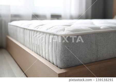 Mattress. Bed with comfortable orthopedic mattress in light room. Quilted white mattress for restful healthy posture sleep. Softness supported by layers inside fabric seal. Memory Foam Core Mattress Mattress. Bed with comfortable orthopedic mattress in light room. Quilted white mattress for restful healthy posture sleep. Softness supported by layers inside fabric seal. Memory Foam Core Mattress 139138291