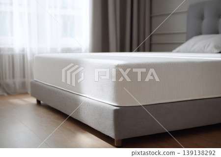 Mattress. Bed with comfortable orthopedic mattress in light room. Quilted white mattress for restful healthy posture sleep. Softness supported by layers inside fabric seal. Memory Foam Core Mattress Mattress. Bed with comfortable orthopedic mattress in light room. Quilted white mattress for restful healthy posture sleep. Softness supported by layers inside fabric seal. Memory Foam Core Mattress 139138292
