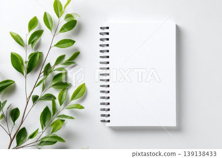 Notebook with plant. Open spiral notepad on white color background desk table. Blank page for write. Back to life, goal list concept. Empty clean writing pad. Resolution, plan, goals, checklist, idea Notebook with plant. Open spiral notepad on white color background desk table. Blank page for write. Back to life, goal list concept. Empty clean writing pad. Resolution, plan, goals, checklist, idea 139138433