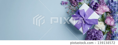 Spring gift. Spring background. Purple Giftbox with flowers on light blue plain color backdrop. Flower pattern banner. Blossom abstract texture. Beautiful Floral wallpaper. Women Day, 8th March 8 card 139138572
