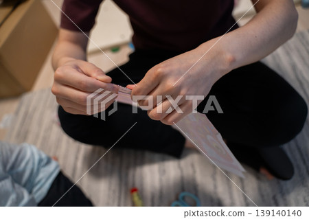 The hands of a man working on a craft project The hands of a man working on a craft project 139140140