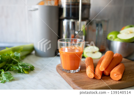Fresh carrot juice close up with celery and apple natural vitamin drink Fresh carrot juice close up with celery and apple natural vitamin drink 139140514