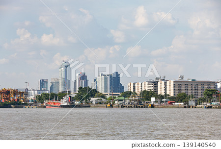 Bangkok shipping container terminal area, The Asian modernize harbor and global trade, background with Bangkok panorama, Tanker in front. 139140540