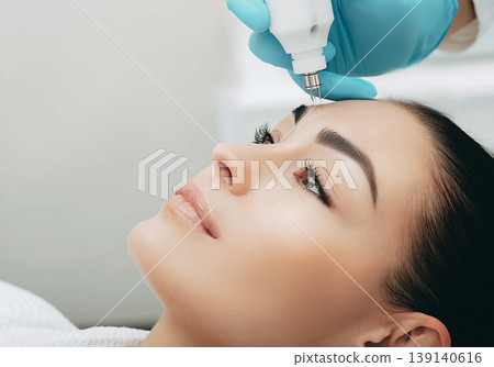 Beautiful woman receiving mesotherapy no-needle. She wants her skin to be young Beautiful woman receiving mesotherapy no-needle. She wants her skin to be young 139140616
