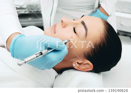 Jet peeling. Procedure renewing skin. Woman wants her skin to look young with with a cosmetic procedure Jet peeling. Procedure renewing skin. Woman wants her skin to look young with with a cosmetic procedure 139140628
