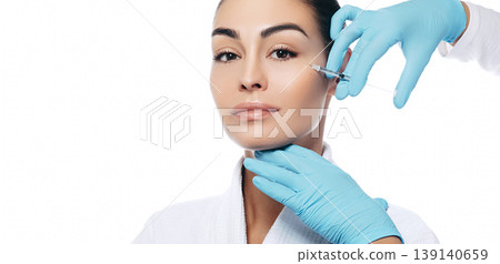 Portrait of beautiful women during facial rejuvenation procedure. Anti-aging injection for facial skin isolated on a white background 139140659