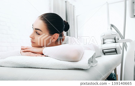 Beautiful woman after lpg massage relaxes on massage table near lpg machine 139140665