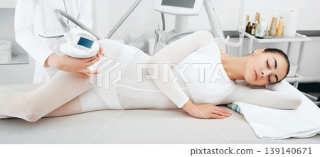 beautiful woman enjoys an LPG massage procedure. Hip cellulite removal 139140671