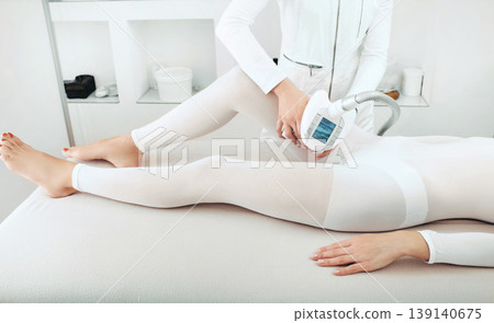 For lpg massage, a woman dressed in a special equipment for the best effect of the procedure. With the help of equipment to remove more cellulite For lpg massage, a woman dressed in a special equipment for the best effect of the procedure. With the help of equipment to remove more cellulite 139140675