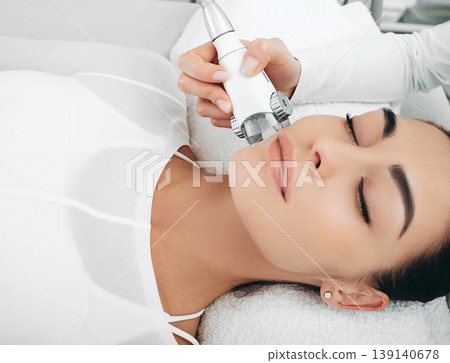 after lpg massage of the face, the woman's face shines with youth and freshness. Anti-aging face contour correction after lpg massage of the face, the woman's face shines with youth and freshness. Anti-aging face contour correction 139140678