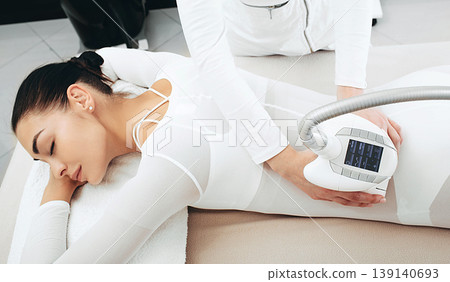 Body rejuvenation of a beautiful woman during a lpg massage. Removal of excess fluid, waste and toxins from the body Body rejuvenation of a beautiful woman during a lpg massage. Removal of excess fluid, waste and toxins from the body 139140693