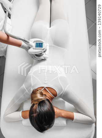 Beautiful woman receiving lpg massage against cellulite Beautiful woman receiving lpg massage against cellulite 139140729